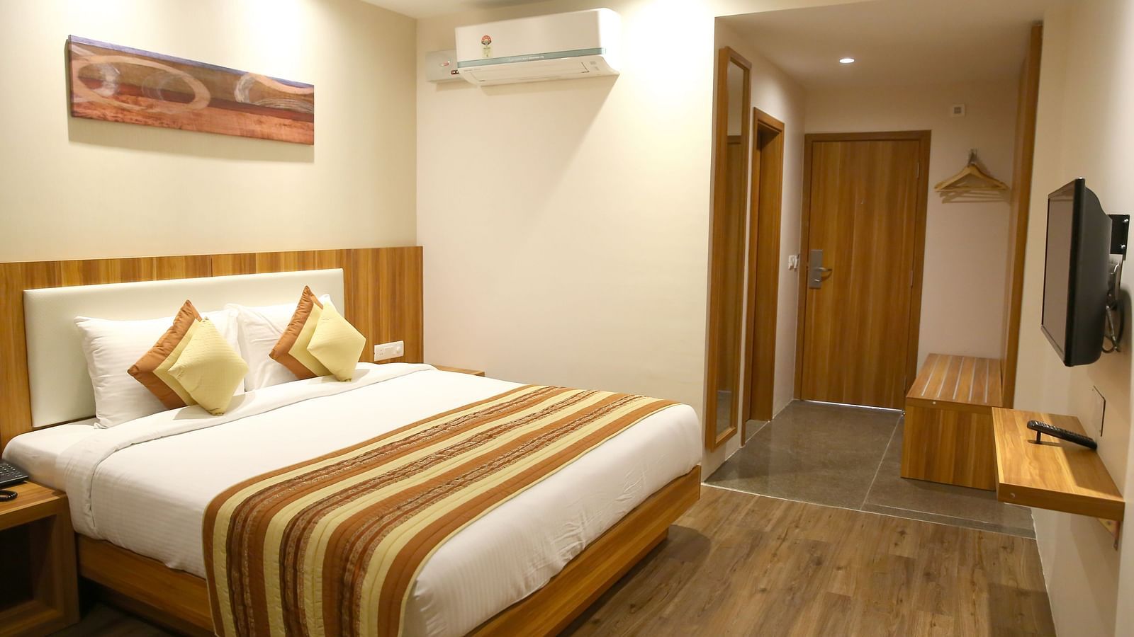 Premium Golden Rooms with Balcony showcasing the modern bedroom with contemporary lighting along with in-room amenities - le roi udaipur hotel3