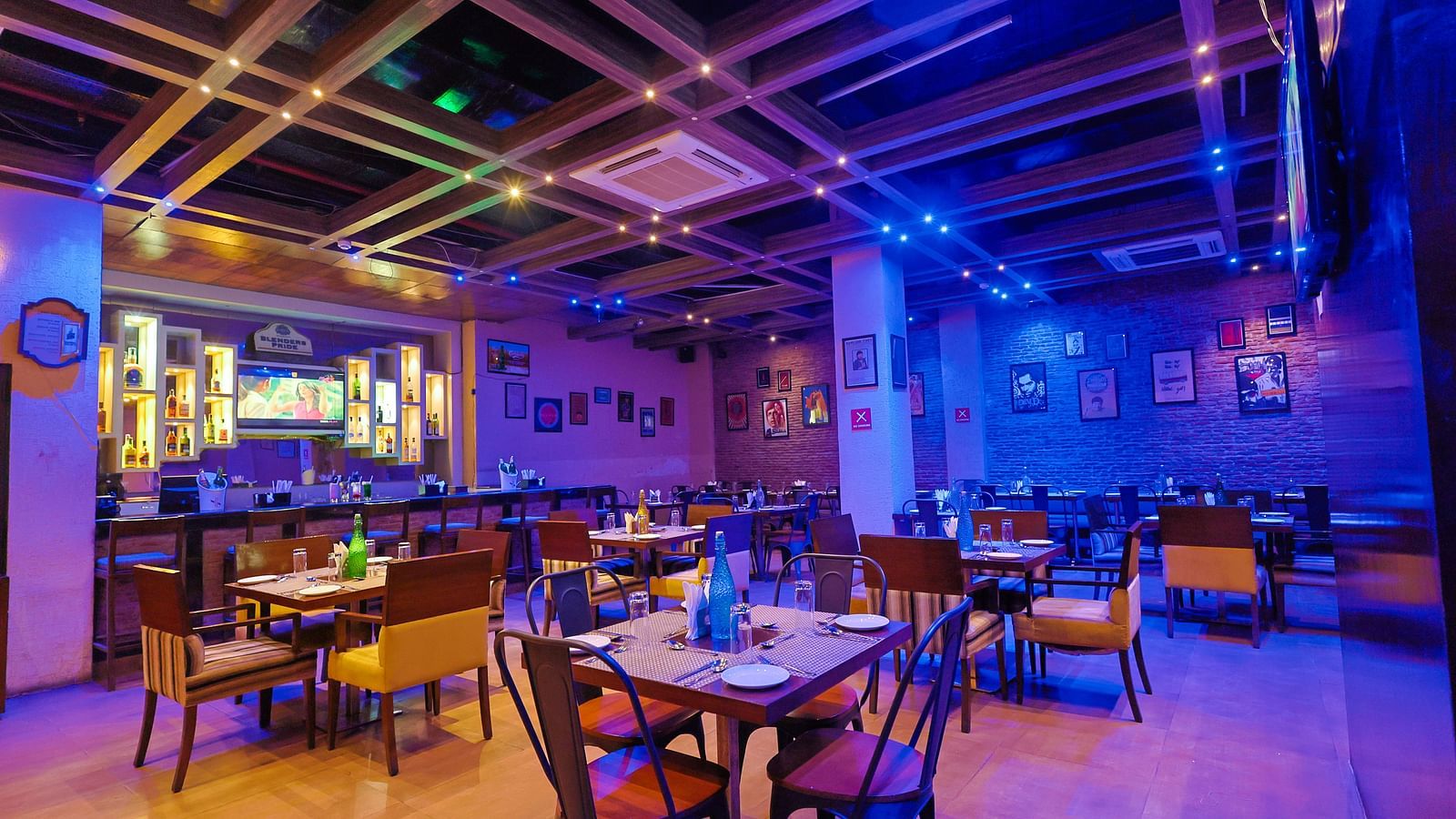  A diagonal view of the restaurant that highlights the ceiling lighting and showcases the spaciousness of the entire setup