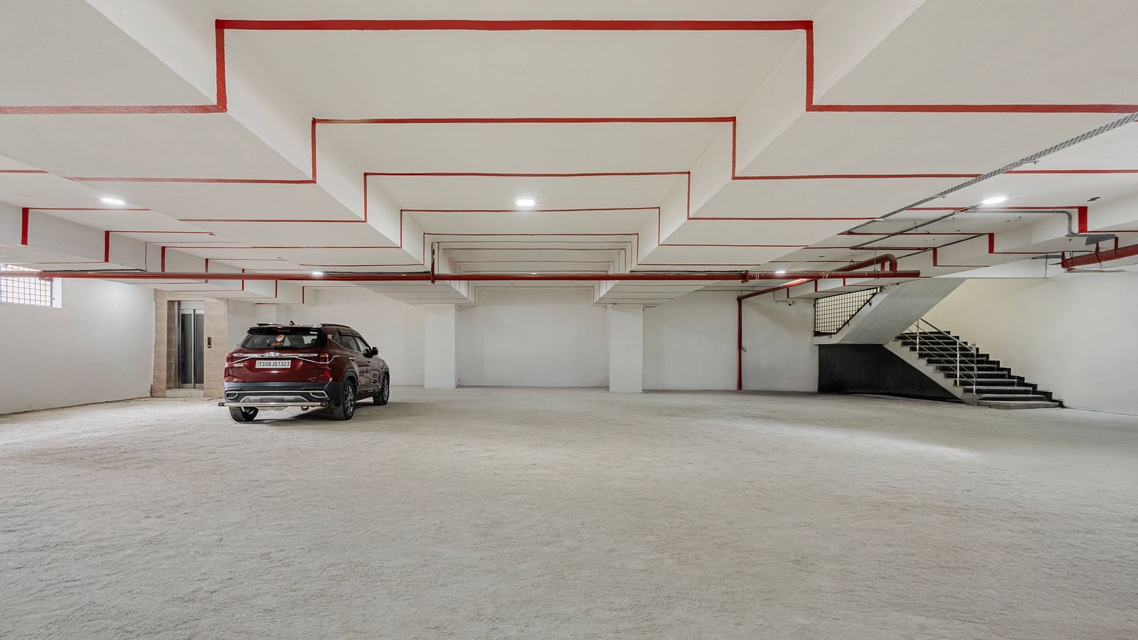 Underground parking area with marked bays at Lemonridge Hotels, IDPL Balanagar.