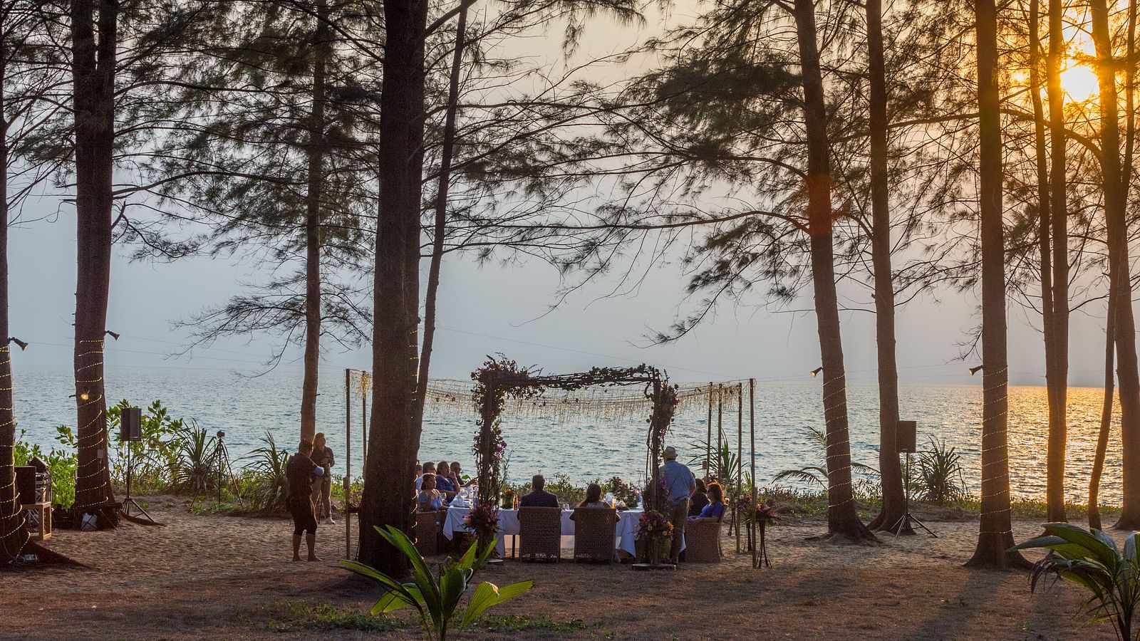The wedding dinner from a far away perspective with a beautiful sunset in the background - Maikhao Dream Villa Resort & Spa, Phuket