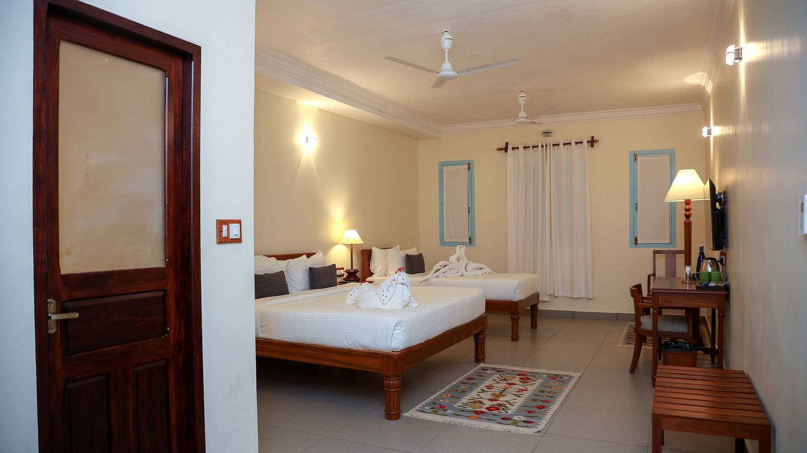 A master suite bedroom with two beds, tables and other furnitures  | Mango Hill La Serene, Pondicherry