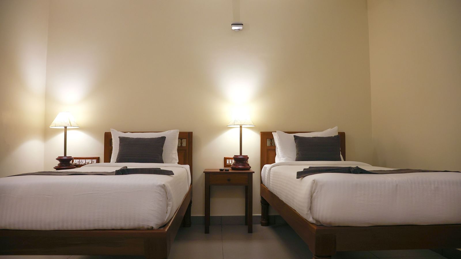 An image of two beds in a room | Mango Hill La Serene, Pondicherry