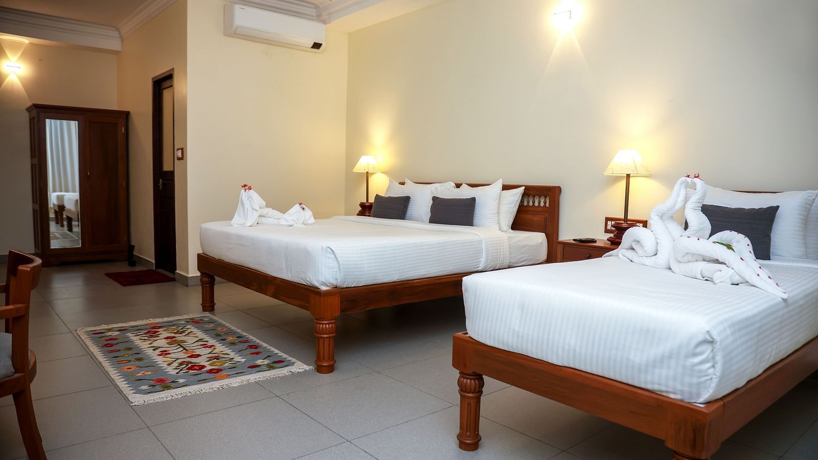 A large bedroom with two beds placed beside each other | Mango Hill La Serene, Pondicherry