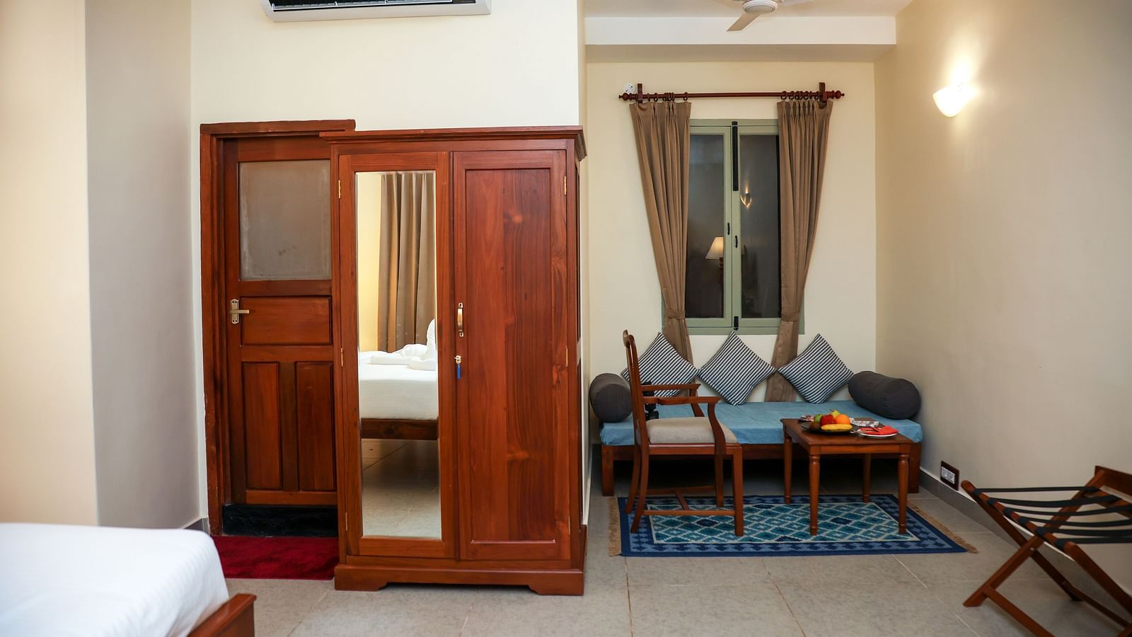 A sitting area, a cupboard, and a tall lamp | Mango Hill La Serene, Pondicherry