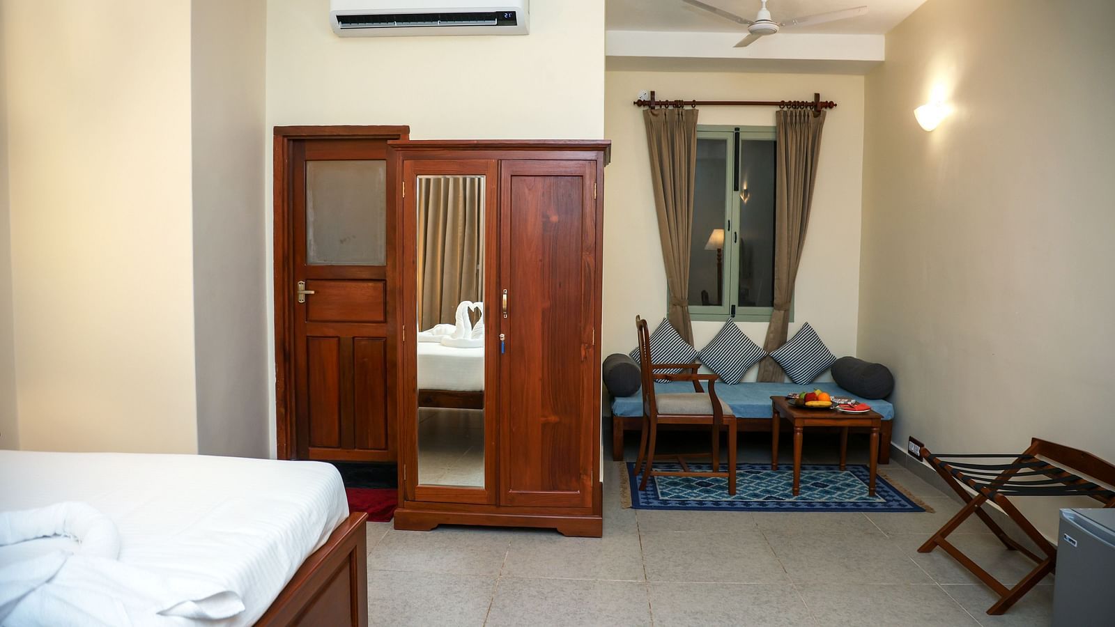 A sitting area, a cupboard, and a tall lamp | Mango Hill La Serene, Pondicherry