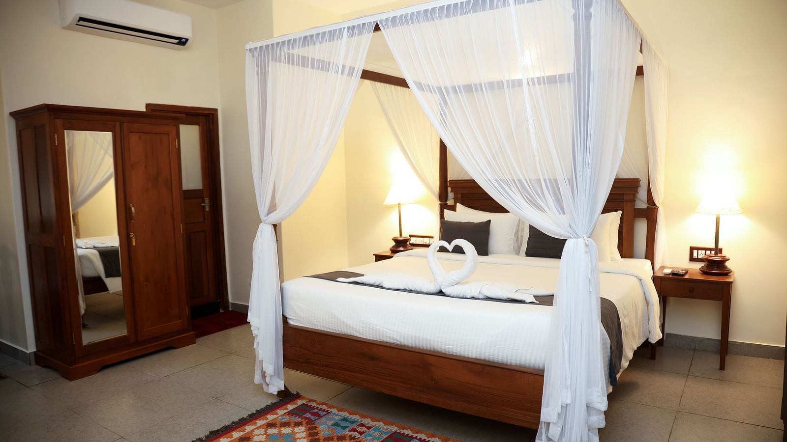 A four-posted bed decorated with pieces of cloth on each angles | Mango Hill La Serene, Pondicherry