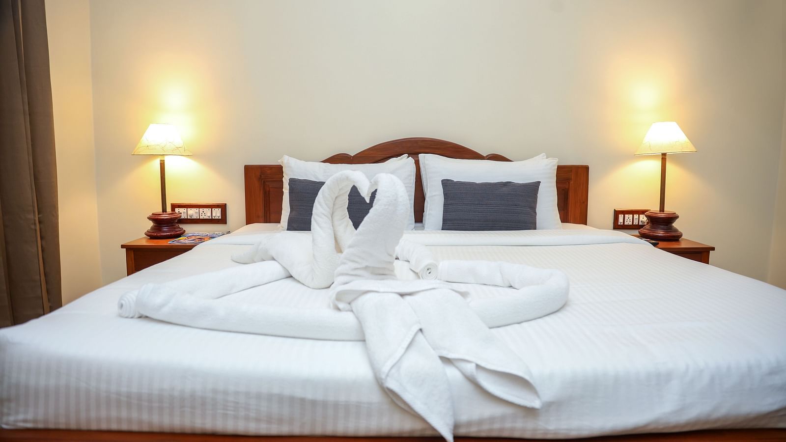 A large sized bed that is decorated with swans made out of towels | Mango Hill La Serene, Pondicherry