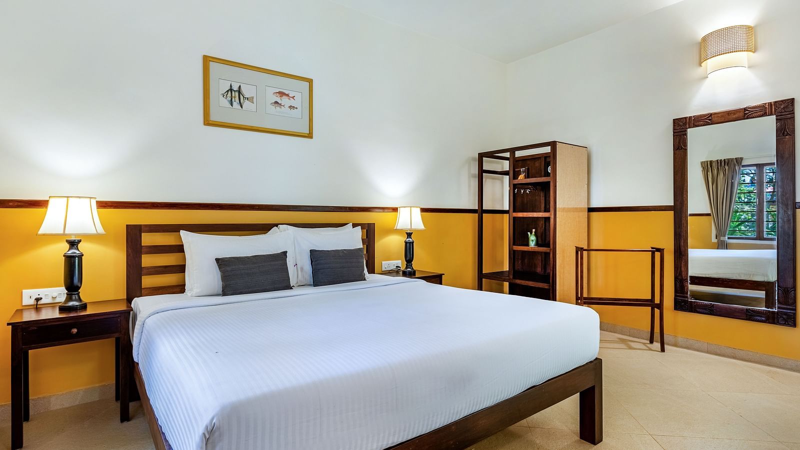  Bedroom with a double bed, nightstands, lamps, a mirror, and a shelving unit | Mango Hill Shallow Beach Resort ECR