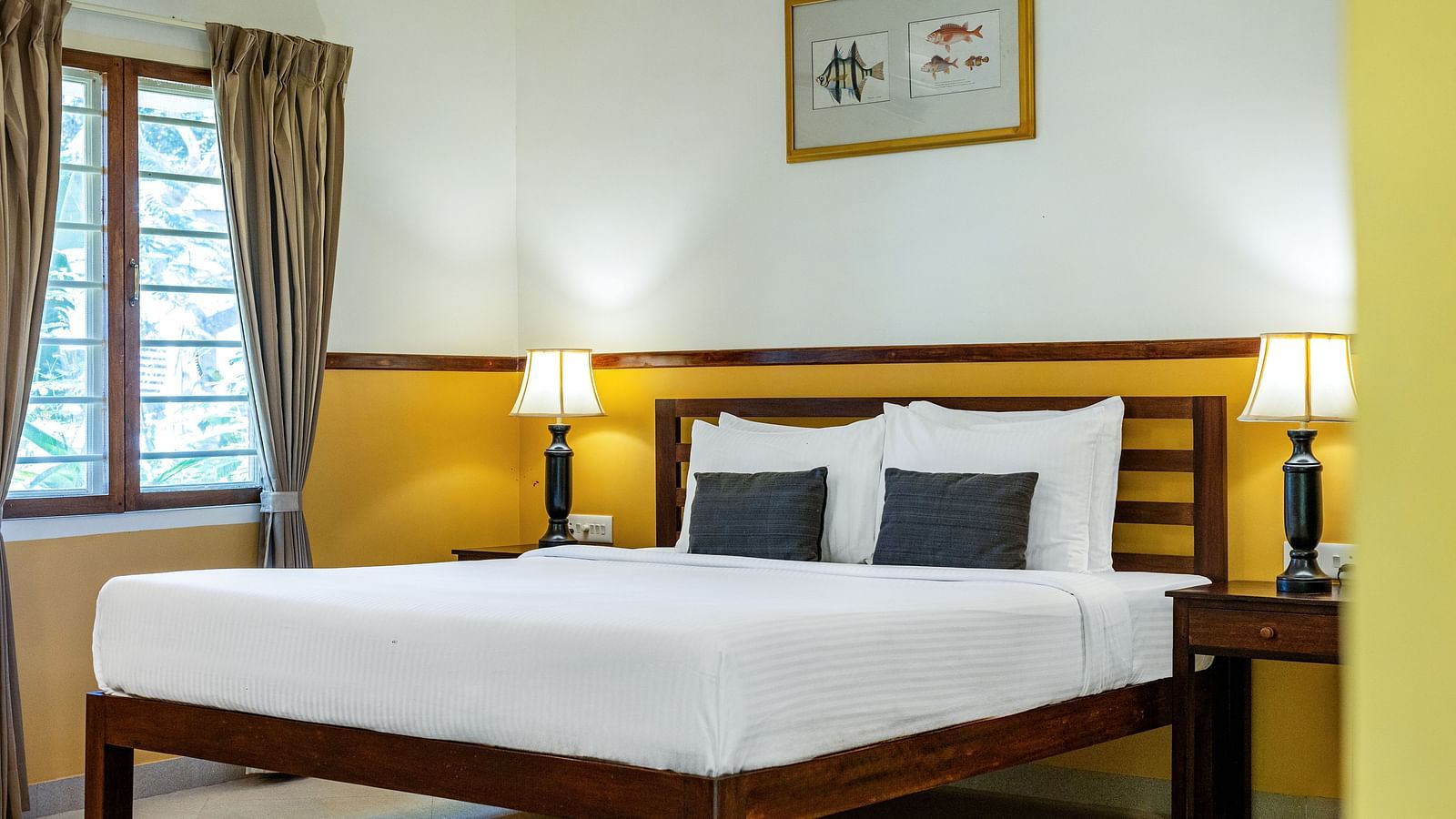  Double bed with nightstands and lamps in a plainly decorated room | Mango Hill Shallow Beach Resort ECR
