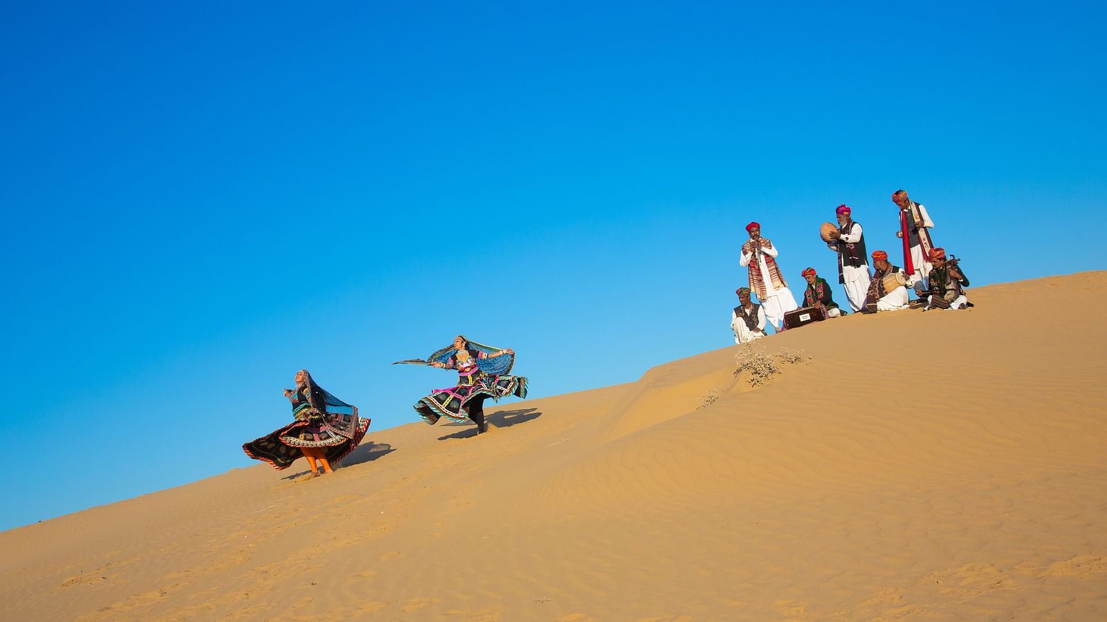 Artisans performing the local dance in the desert