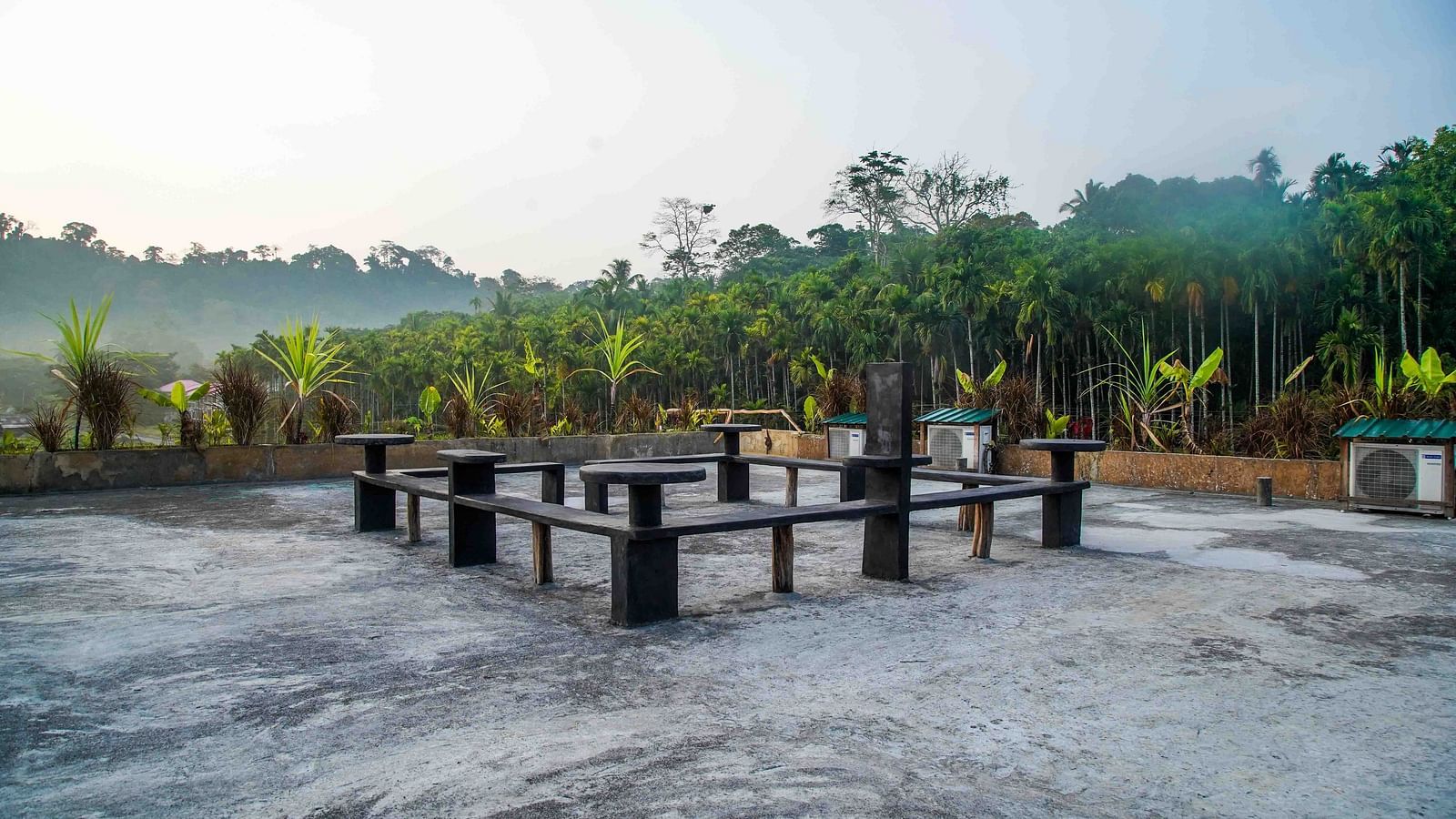  Serene outdoor seating area with lush greenery in the background - Matsya Island Retreat by Island Quest.