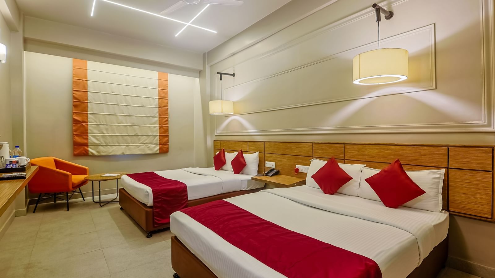 Spacious room with two beds and stylish decor at Max Hotel Prayagraj.