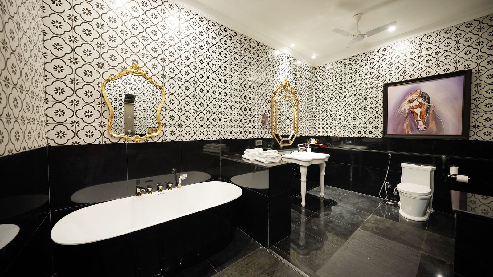 Modern bathroom with freestanding tub and monochrome tile walls at MAYFAIR Tea Resort, Siliguri