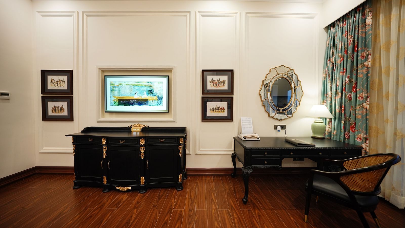 Luxury writing desk and classic wall art in a well-lit suite at MAYFAIR Tea Resort, Siliguri