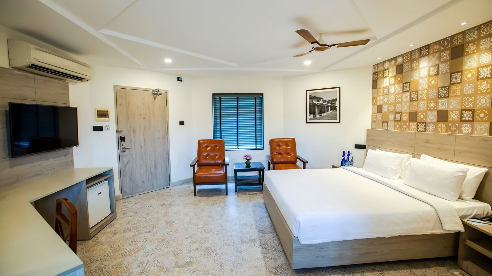 Interior of Sea View Cottage, decked with a bed, television and seating area at MGM Beach Resorts 