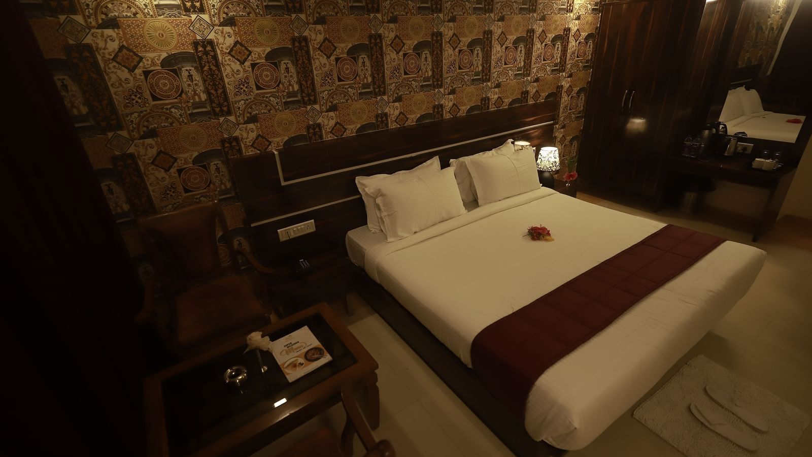 A Deluxe Room of Mountview Resort furnished with a king size bed, a wardrobe, bedside tables, and a seating area.