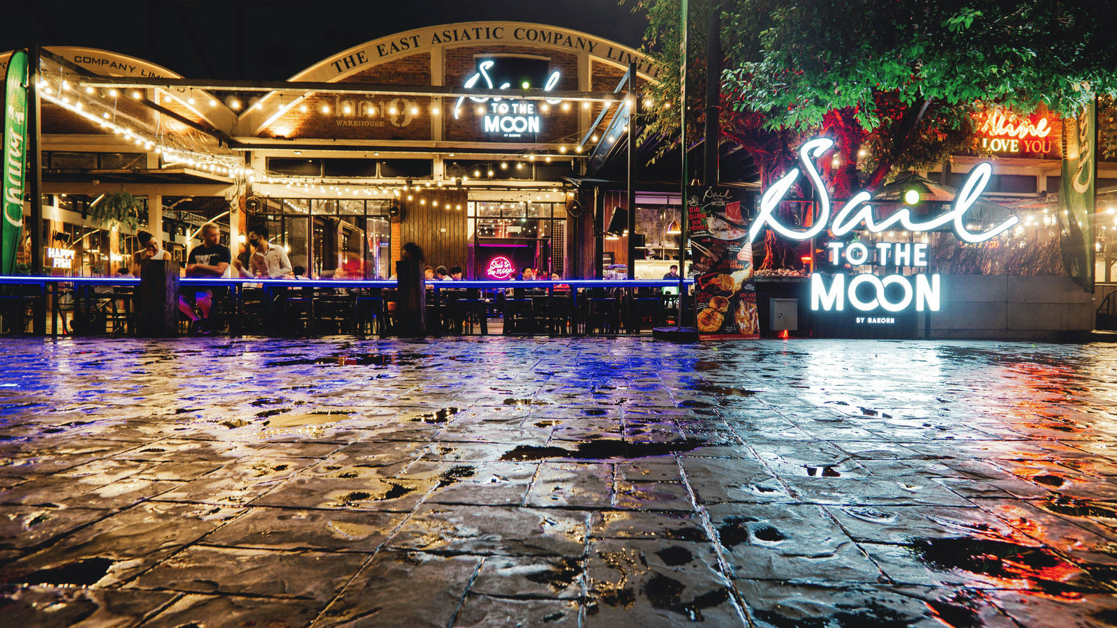 Facade view of Asiatique The Riverfront with signs of many restaurants in view. 