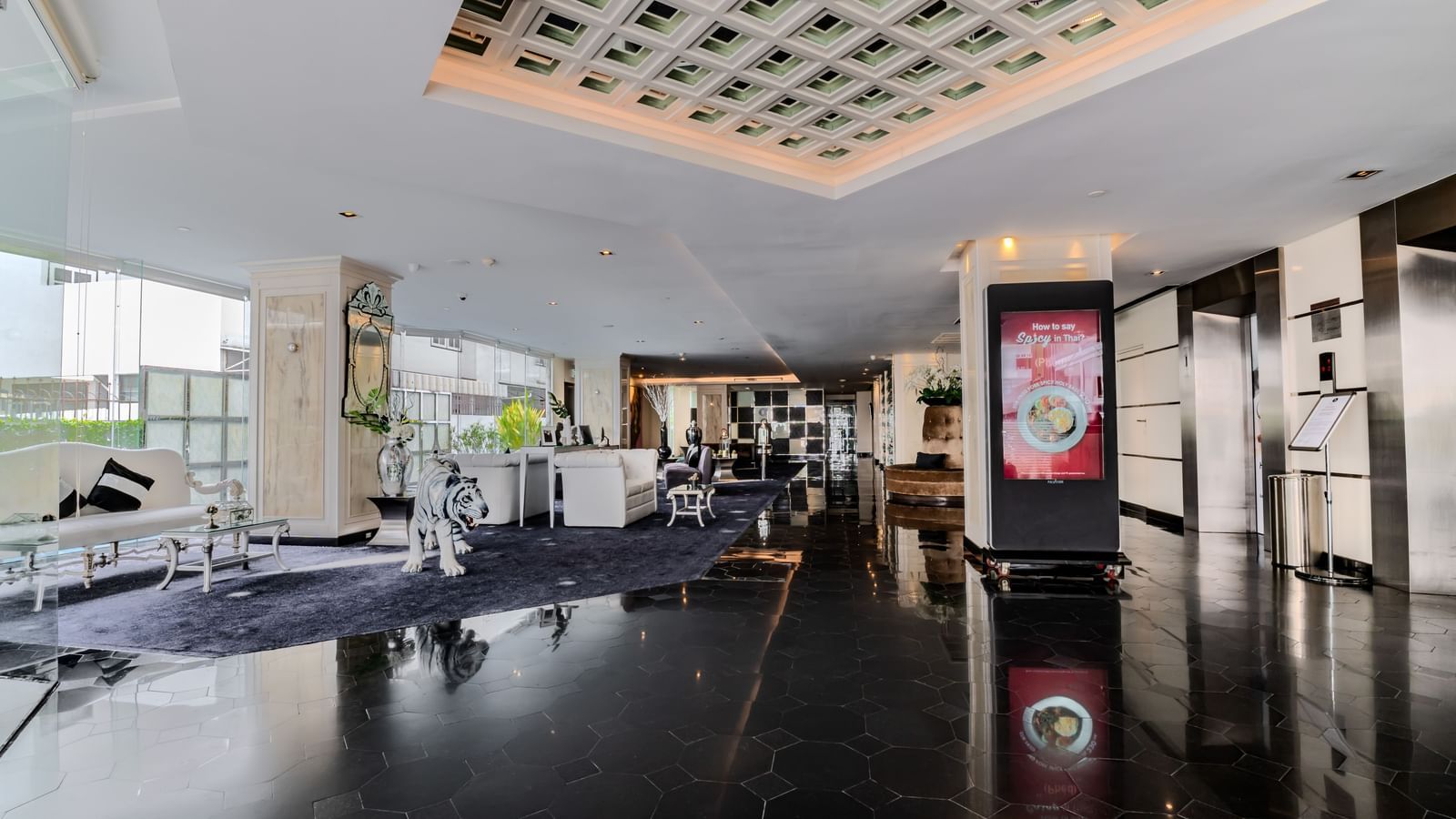 An overview of the lobby area of Night Hotel Bangkok with sofas next to the window.