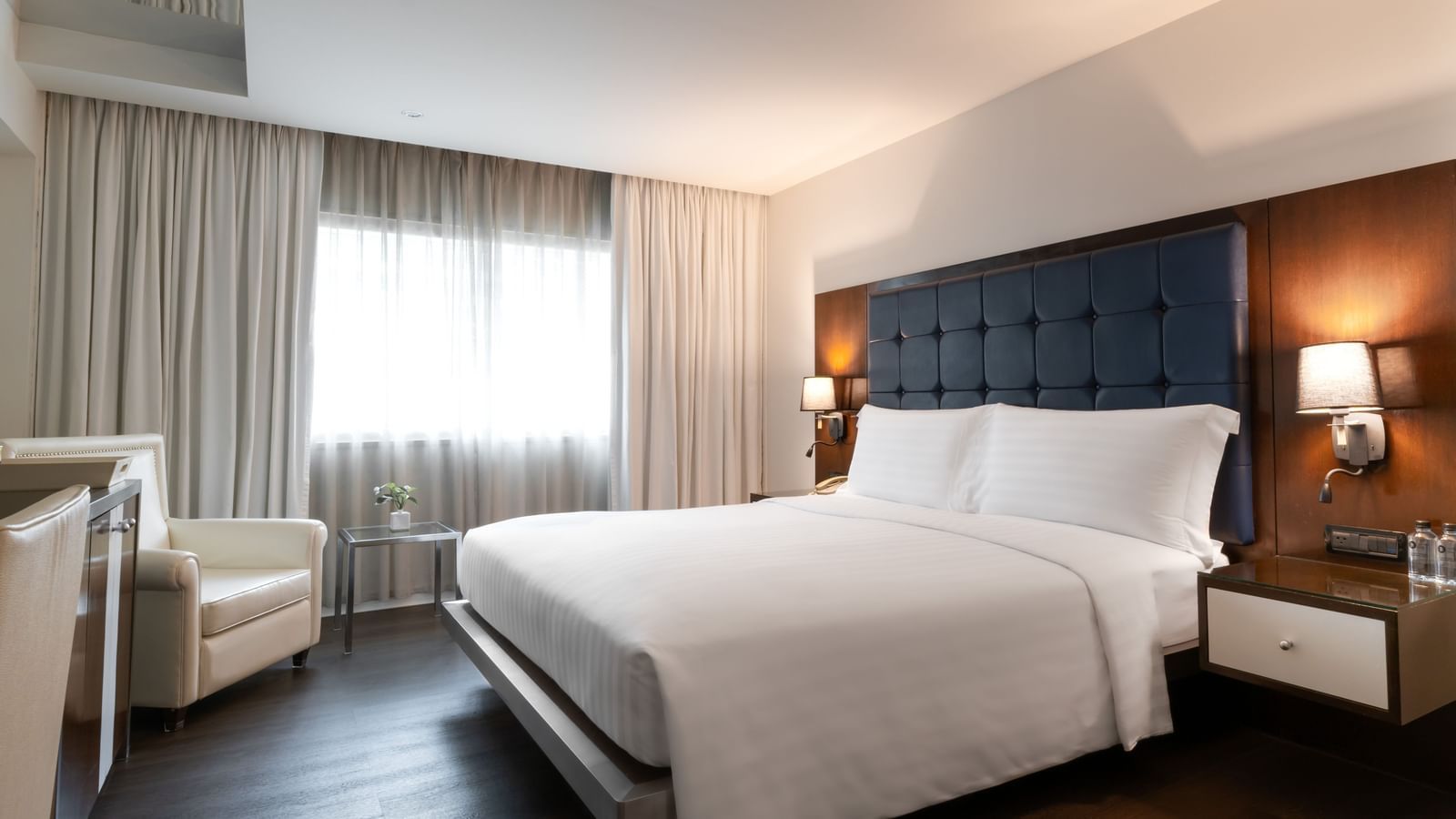 An overview of a double bed with lamps on the side inside one of the rooms - Night Hotel Bangkok, a Hotel with a Pool in Bangkok.