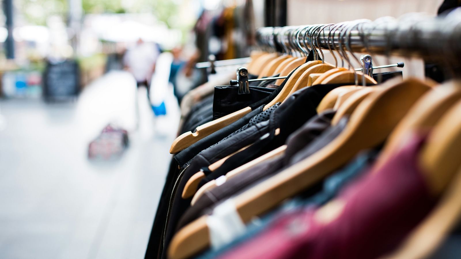 A close up shot of clothes in a hanger inside a shop to be sold.