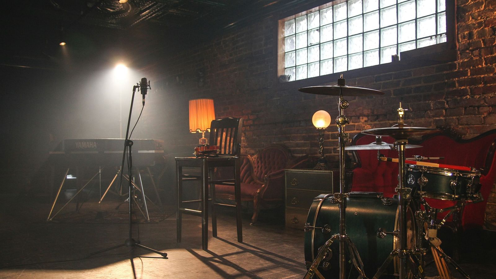 an empty stage with all music equipment and a stage light focussed on the stage