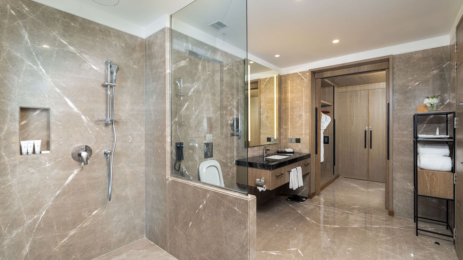 Modern Nirvana Suite bathroom showcasing a sleek glass-enclosed shower, contemporary sink fixtures, and refined design - Nirvana Luxury Hotel, Ludhiana