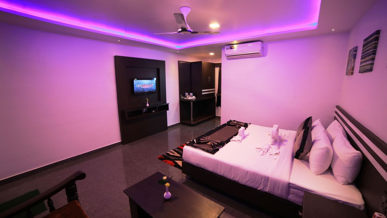 Image of a room with a bed and a sitting area on the side at Parampara Residency, Kushalnagar.