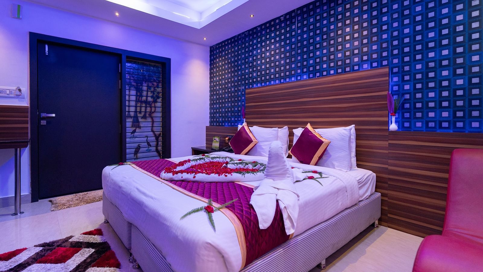 Image of a room with a bed decorated with towels and flowers at Parampara Resort & Spa, Kushalnagar.