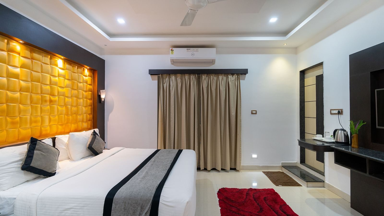 Side view of a room with a bed and a television in front of it at Parampara Resort & Spa, Kushalnagar.