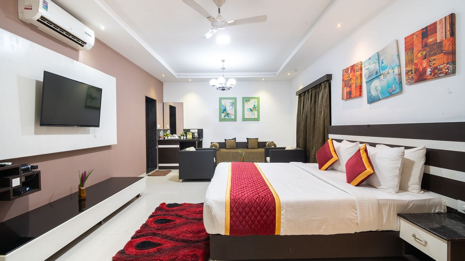 Side view of a room with a bed and a television in front at Parampara Resort & Spa, Kushalnagar.