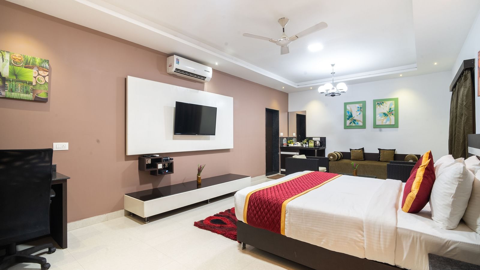 Side view of a room with a bed and a television in front at Parampara Resort & Spa, Kushalnagar.