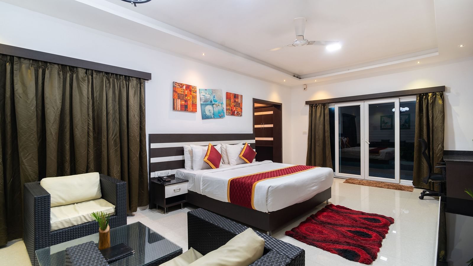 Image of a room with a bed and a seating area on the side at Parampara Resort & Spa, Kushalnagar.