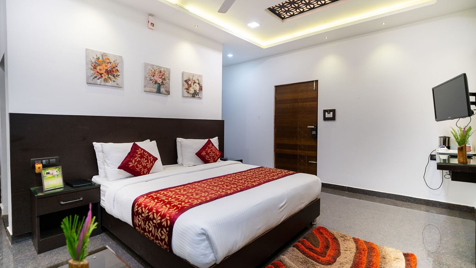 Image of a room with a bed with a rug placed in front of it at Parampara Resort & Spa, Kushalnagar.