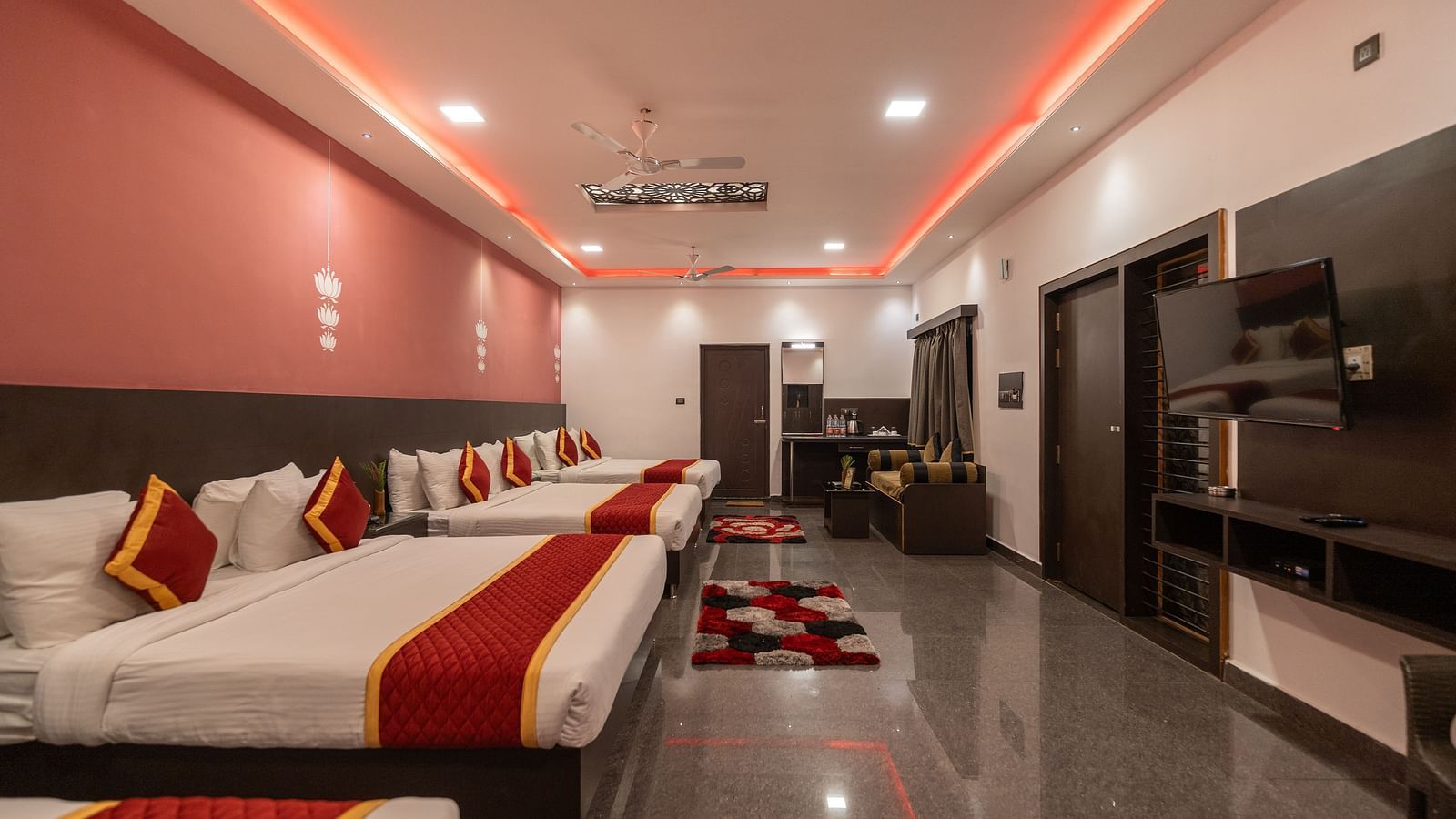 Image of a room with four beds and a television in front at Parampara Resort & Spa, Kushalnagar.