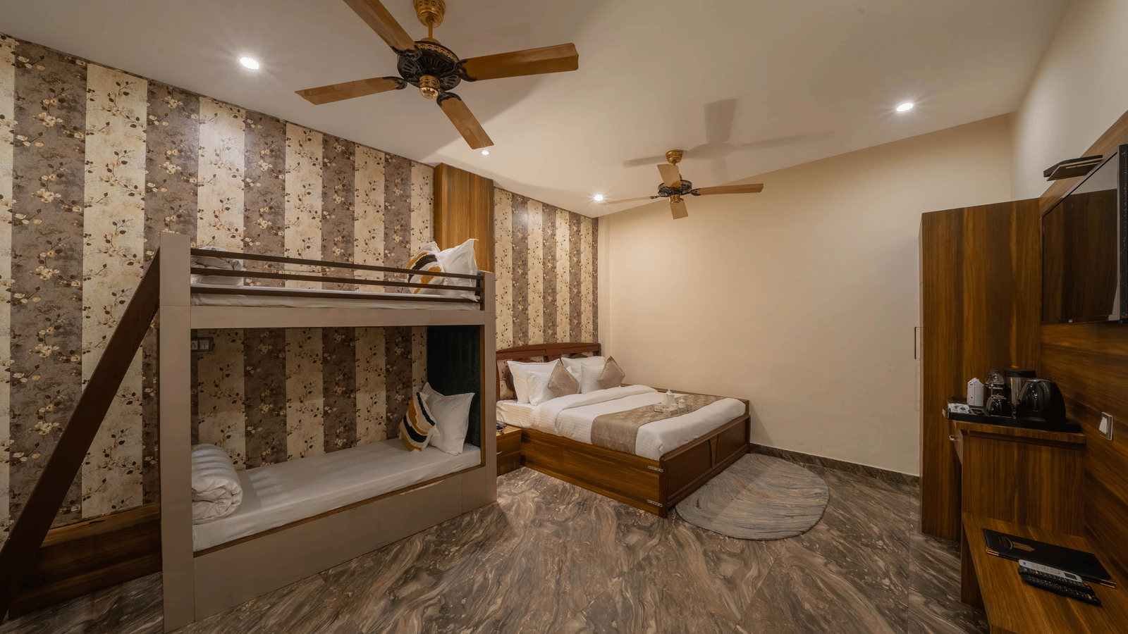 Hotel room view featuring a double bed, bunk beds, and a ceiling fan - Perfectstayz Premium at Har Ki Pauri Road (Ganga Heights)