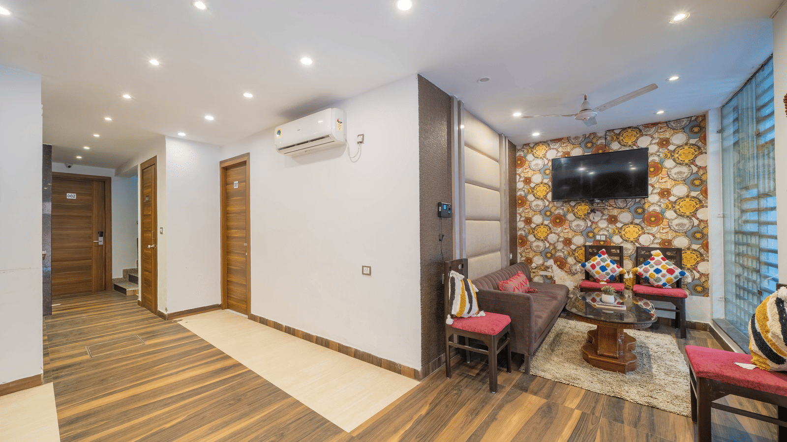 Hotel lobby or common area featuring a sitting arrangement and wooden flooring - Perfectstayz Premium at Har Ki Pauri Road (Ganga Heights)