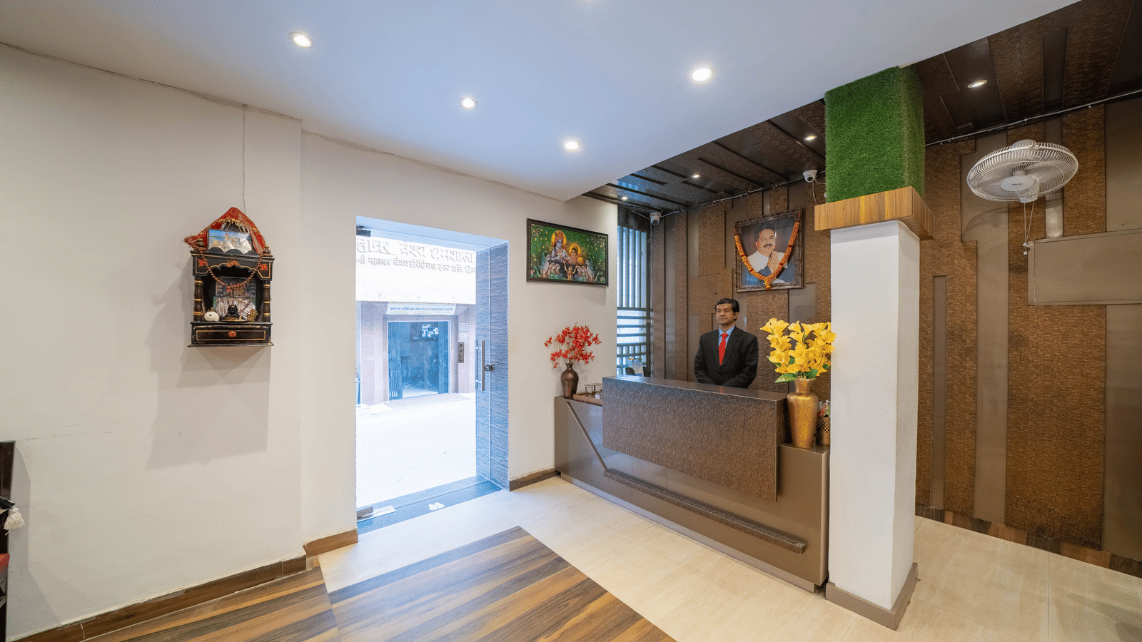 Hotel reception area with a check-in desk, warm lighting, and wood panelling - Perfectstayz Premium at Har Ki Pauri Road (Ganga Heights)