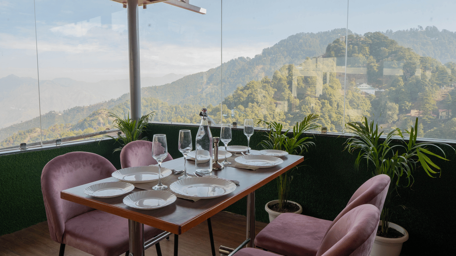 A dining setup with chairs and table facing mountain view at Perfectstayz Premium at Mall Road Hotel Super, Mussoorie.