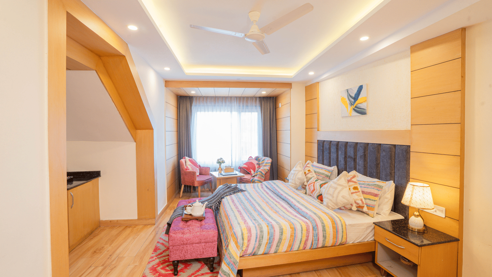 A bedroom with a bed, lamps, and wall art at Perfectstayz Premium at Mall Road Hotel Super, Mussoorie.