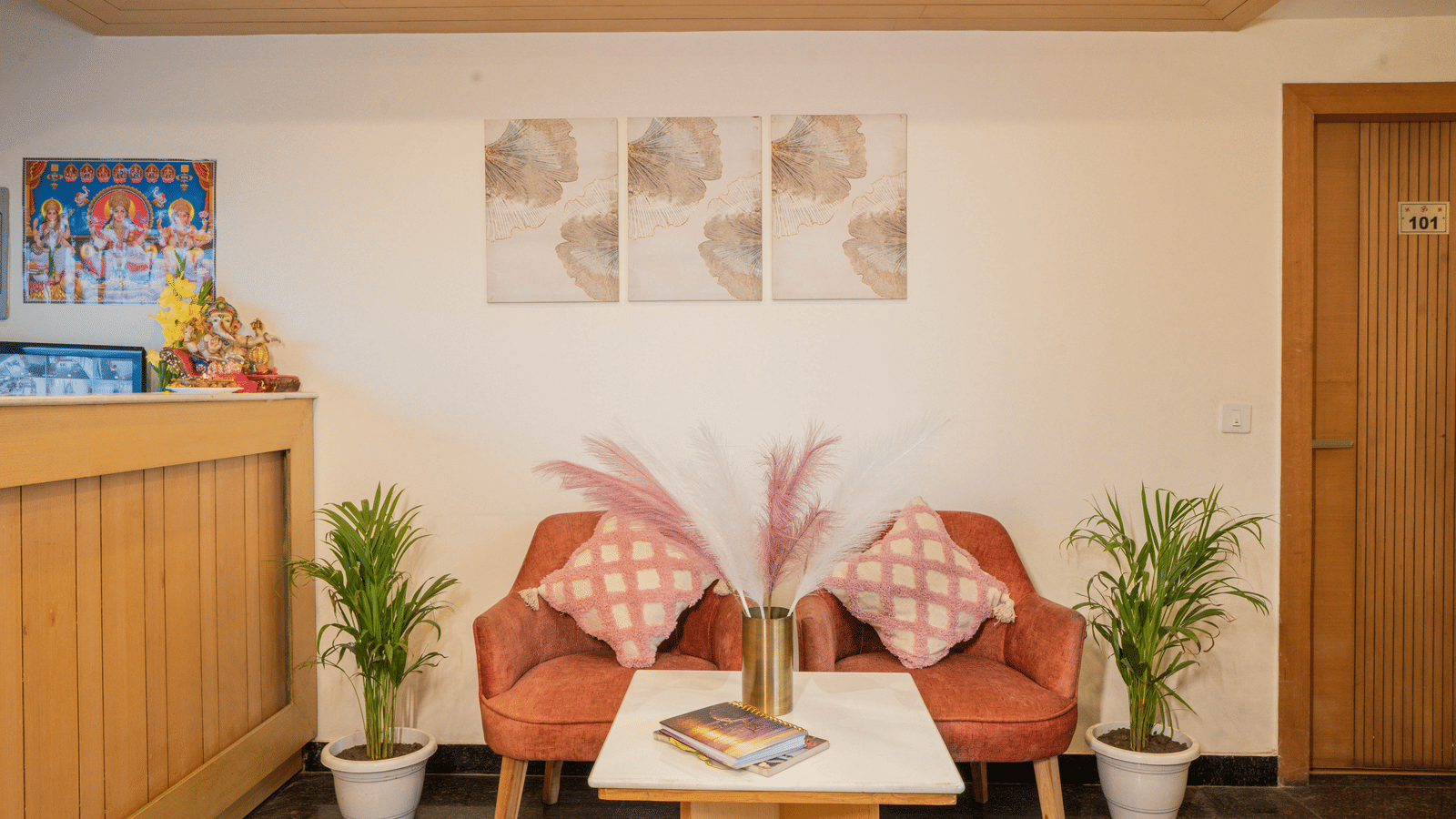 A seating area with chairs, table, and wall art at Perfectstayz Premium at Mall Road Hotel Super, Mussoorie.