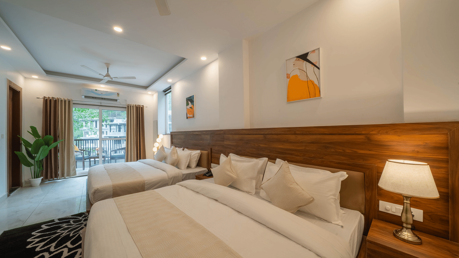 A room with 2 beds, a wooden headboard, a lamp on a bedside table, and a picture frame on the wall in Perfectstayz Premium Mystic Falls, Rishikesh.