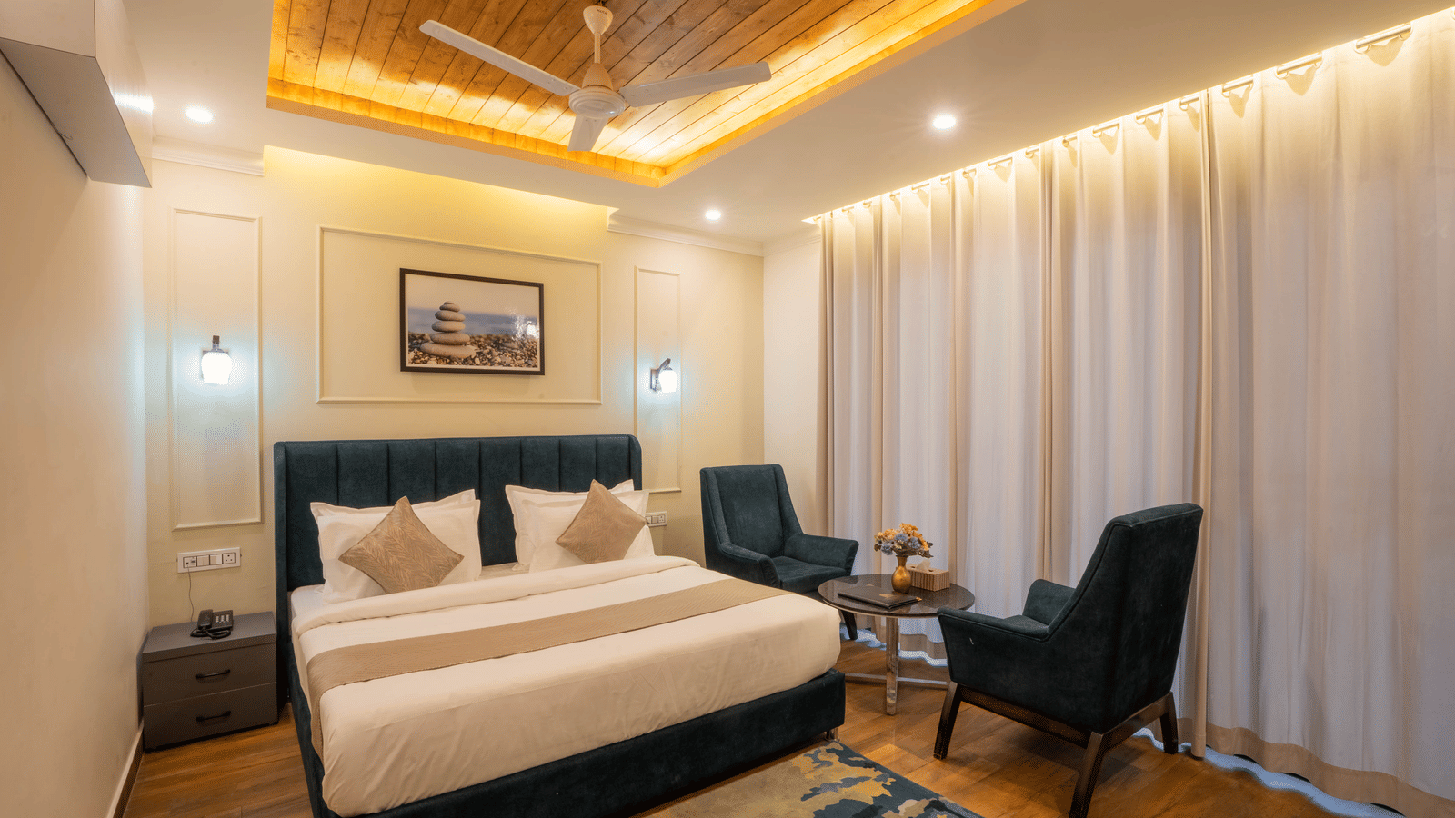 Full view of the Super Deluxe Room With Balcony featuring a double bed in the middle of the room along with the curtains covering the balcony windows at Perfectstayz Premium Westend Mall Road, Mussoorie.