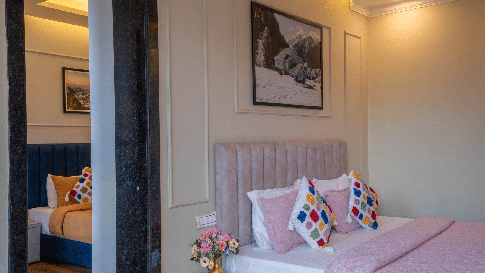 A close-up shot of the double bed at Family Suite With Shared Balcony & Valley View featuring a bed-side table with a small flower vase besides a doorway at Perfectstayz Premium Westend Mall Road, Mussoorie.