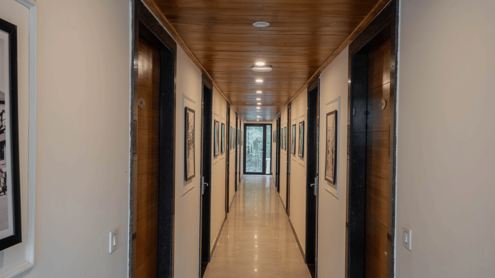 A mid shot of a brightly-lit corridor at the Perfectstayz Premium Westend Mall Road, Mussoorie.