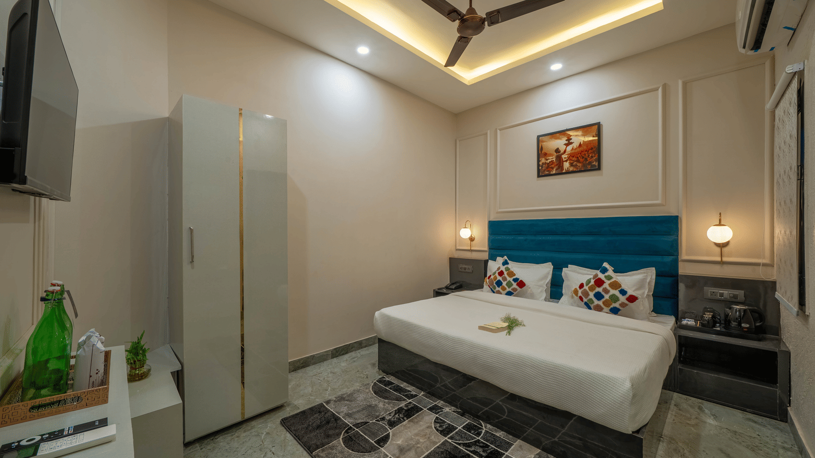 Interior view of a modern bedroom with a white bed, a white wardrobe, and a TV mounted on the wall - Perfectstayz Value Aalaya Suites, Haridwar