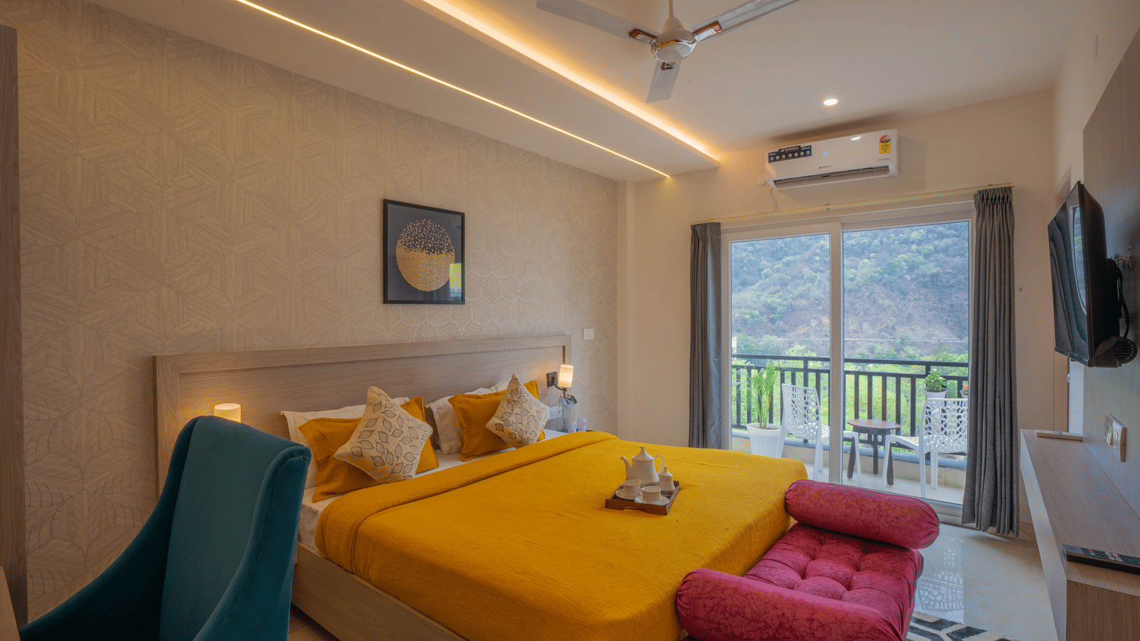 A contemporary double bedroom at Perfectstayz Value Alpine Retreat, Rishikesh with bright yellow bedding and a glass door leading to a balcony.