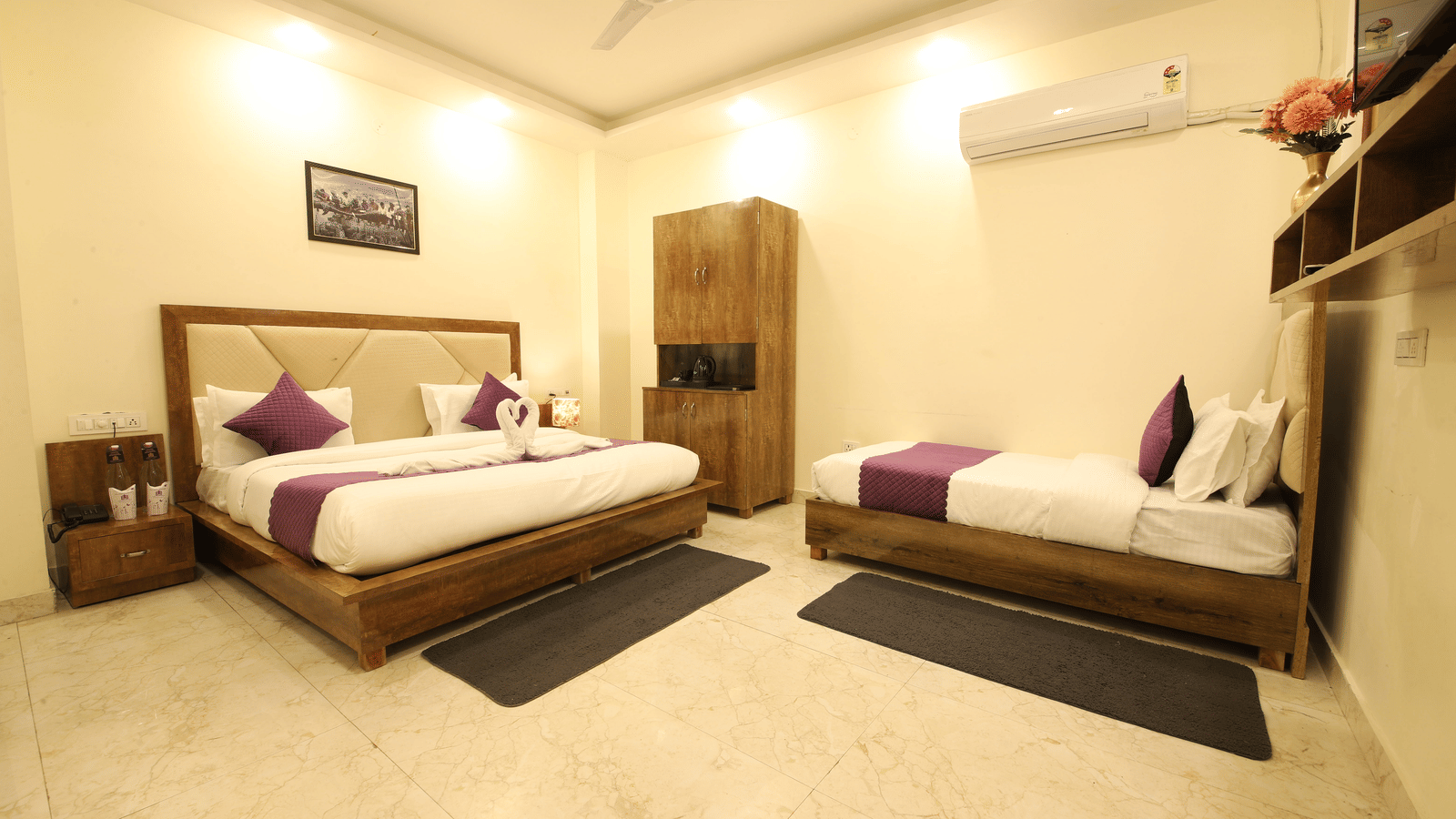 A hotel room, featuring 2 beds with white linens and purple accent runner, a dark wooden headboard and frame, nightstands, and beige tiled floor | Perfectstayz Value Hills, Rishikesh
