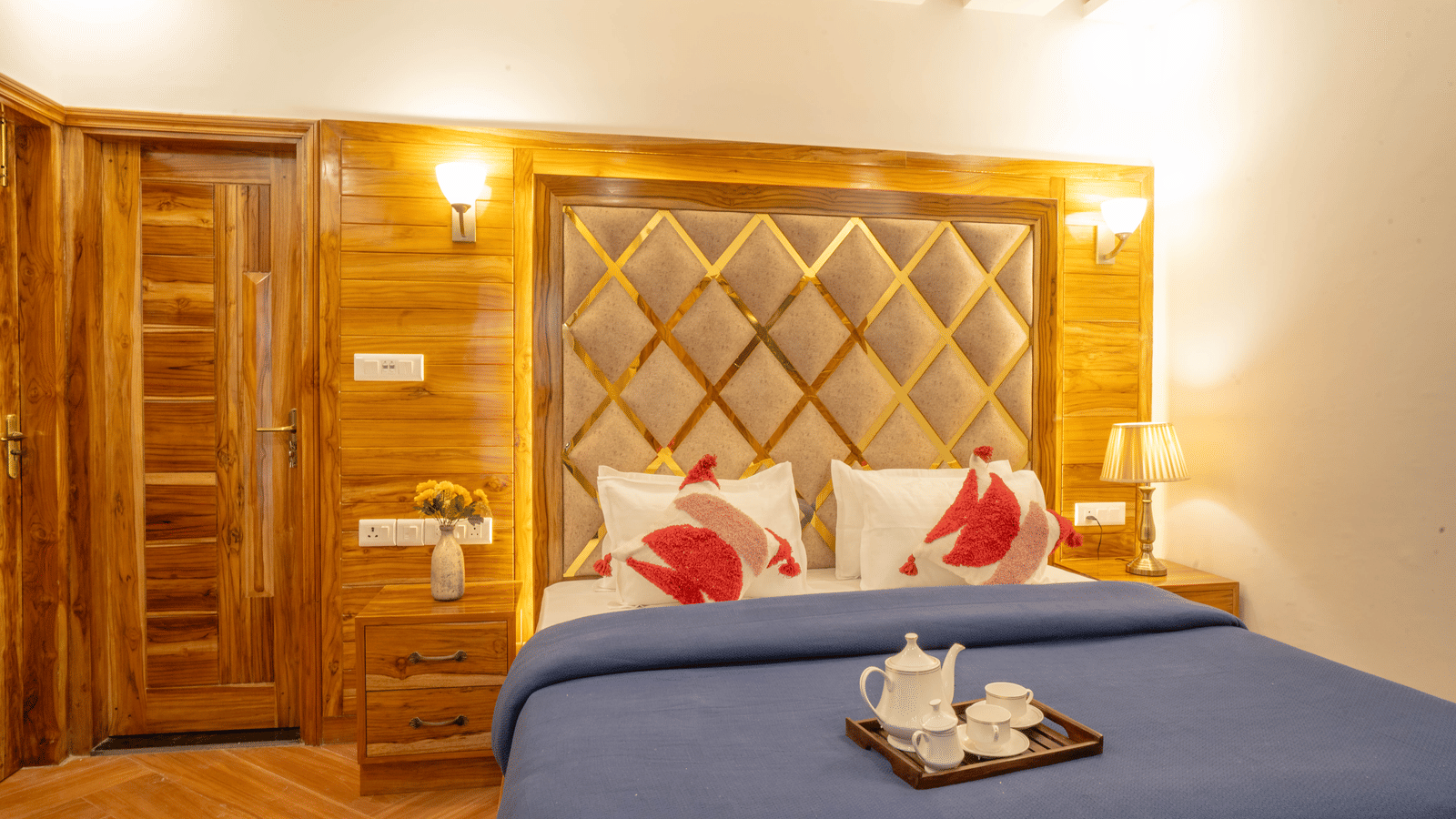 A bedroom featuring a king size bed, 2 bedside tables and a tray with cups and a kettle at Perfectstayz Value Paradise, Mussoorie.