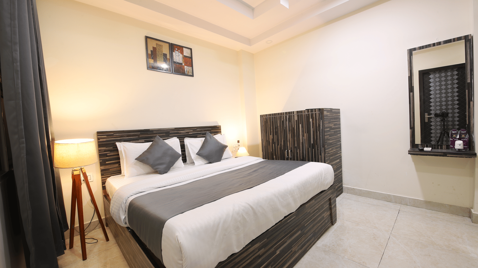 Minimalist hotel room with bed, side table, and seating area - Perfectstayz Value Umra Grace, Haridwar