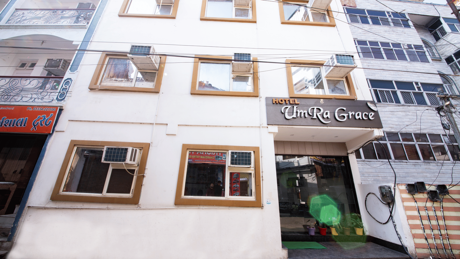 Exterior view of the multi-story hotel building with many windows - Perfectstayz Value Umra Grace, Haridwar